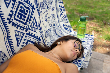 Teenage girl relaxing outdoors on park bench
