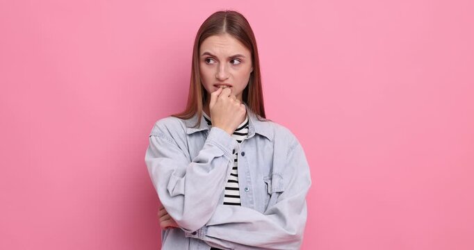 Nervous woman in stylish clothes on pink background