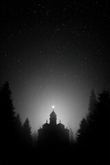 A silhouetted church, veiled in fog, stands majestically beneath a starlit sky; a single light source illuminates its dome