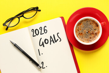 Notebook with empty to do list, eyeglasses and cup of coffee on yellow background. New year goals