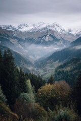 Fototapeta premium Misty mountain valley scene, showcasing snow-capped peaks in the distance, a small village nestled amidst autumnal forests in the foreground, a sense of depth and serenity