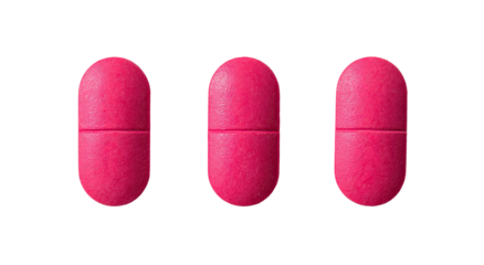 Three pink oval pills on black background