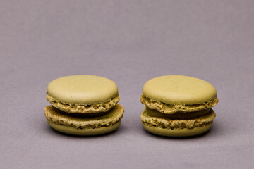 Two green macarons on gray background