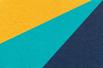 Fototapeta premium Abstract old geometric paper background with yellow, turquoise, navy blue rays, macro texture for banner, template