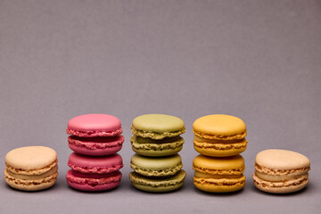 Four assorted macarons on gray background