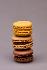 Stack of four macarons assorted colors on gray background