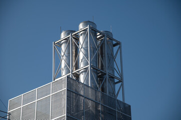 A large metal structure with four tanks on top of it