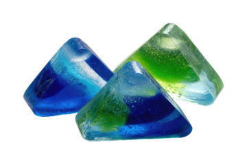 Three triangular, translucent candies in shades of blue and green