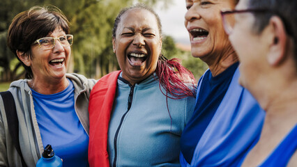 Senior friends, Happy older people have fun after yoga sport class hug outdoors in park city....