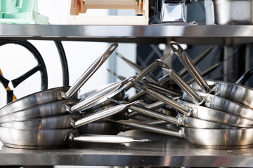 Stacked metal frying pans arranged in two stacks