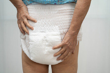 Asian senior woman patient wearing incontinence diaper.