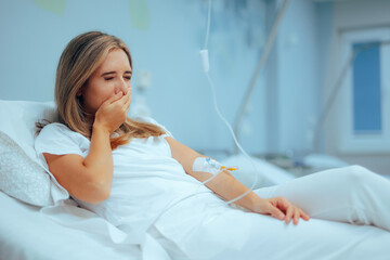 Nauseous Patient in a Hospital  Receives Antiemetic by Infusion. Woman feeling sick having nausea...