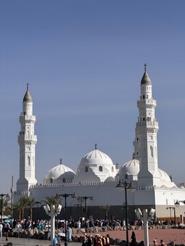 Quba Mosque with White Domes and Minarets in Medina, People Gathered Outside