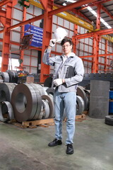 Industrial Engineer in Hard Hats Work at the Heavy Industry Metal Sheet Manufacturing Factory. Factory worker indoors in metal sheet factory. Man working in an industrial factory. 
