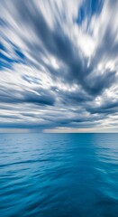 Obraz premium Dramatic Sky Over Calm Ocean with Radial Blur Effect.