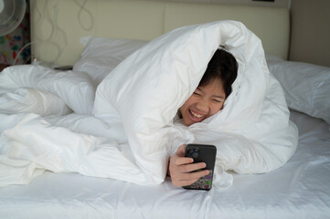 kid watching tablet on the bed, child addicted cartoon