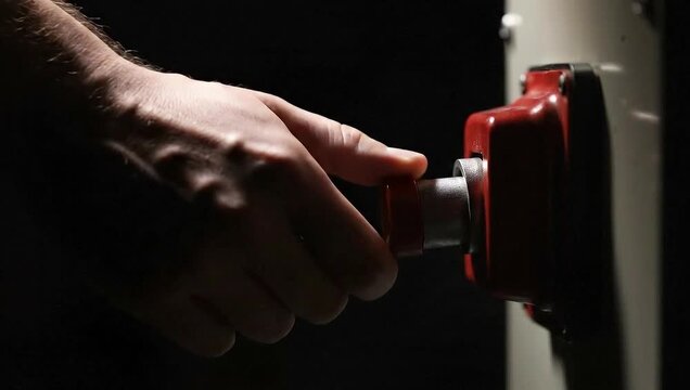 Pressing Red Emergency Stop Button on Industrial Machine
