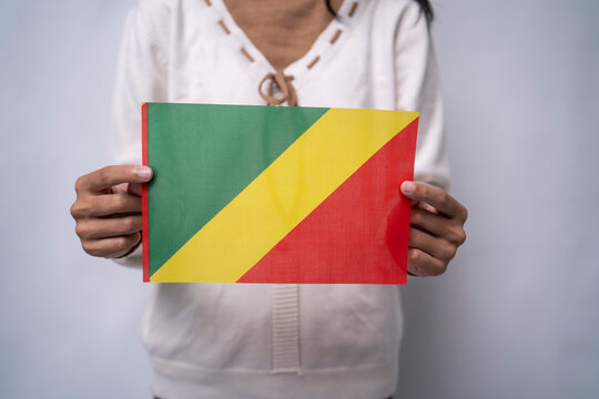 Person Holding the Flag of the Republic of the Congo - Powered by Adobe