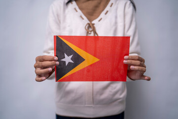 Person Holding the Flag of Timor Leste