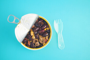 Colorful canned mixed beans on a bright background