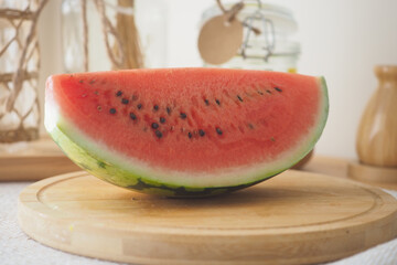 Fresh watermelon sliced on a wooden cutting board
