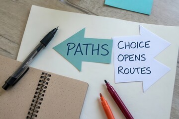Arrows with words Paths and Choice Opens Routes on a desk