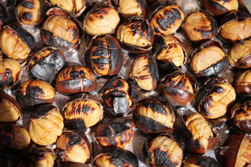 Delicious roasted chestnuts displayed on a warm surface