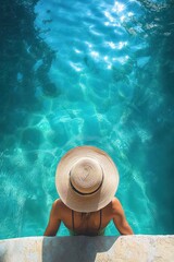 Woman wearing a wide-brimmed straw hat relaxing at the edge of a clear blue swimming pool with sparkling water under sunlight