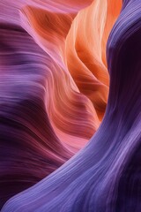 Obraz premium Smoothly carved narrow canyon walls with flowing shapes in vibrant purple and warm orange hues showcasing natural geological formations and textures