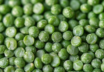 Close-up view of numerous green frozen peas covered with frost and ice crystals