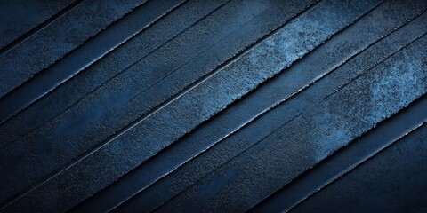 close-up of textured metallic surface with diagonal ridges in various shades of dark blue and black
