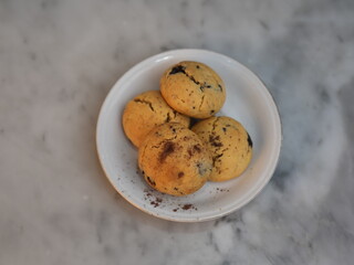 Golden cookies with melty chocolate, one broken to reveal soft interior