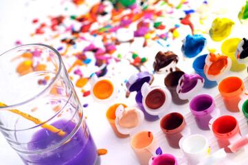 Close-up view vibrant abstract painting, featuring splashes blue, yellow, and pink paint on white background