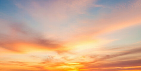 Vibrant orange and blue sunset sky with wispy clouds fills the frame, painting a dramatic and colorful scene that highlights the beauty of nature&rsquo;s evening glow and the transition into twilight.
