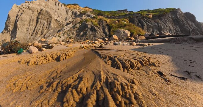 Timelapse video of ground water / storm water and silt / sand forming a small Alluvial Fan on a beach.