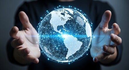 Human hands holding digital earth globe with connection network and blue light effects on dark background. Concept for global business, international network and worldwide communication