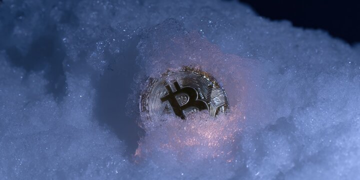 Professional Crypto Investing Concept with Frozen Bitcoin Coin in Snowy Landscape Modern Financial Volatility for Millennial Marketing Campaigns