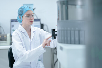 A medical technologist loads a sample rack into an automated immunoassay analyzer, initiating the...