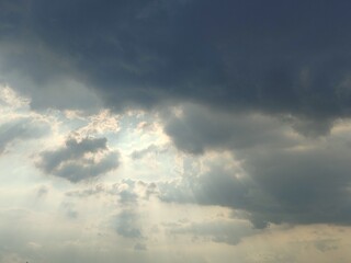 Sunlight breaking through the dark clouds