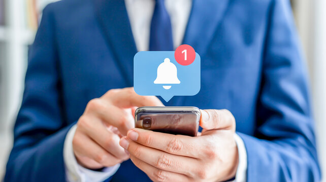 Person using smartphone with notification bell icon - Powered by Adobe