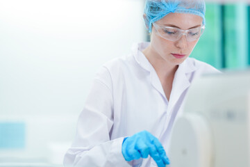 A food scientist in a cleanroom precisely places cell cultures for a 3D bioprinter, pioneering the...