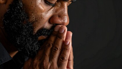 Close-up of man praying to god with hands togethe.