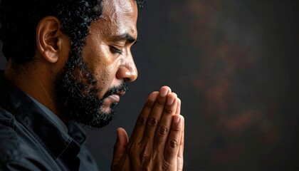 Close-up of man praying to god with hands togethe.