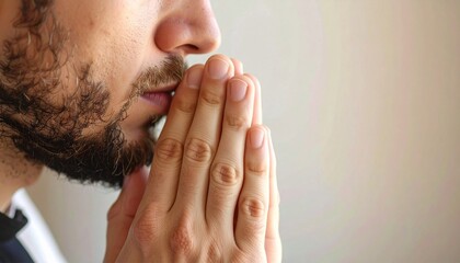 Close-up of man praying to god with hands togethe.