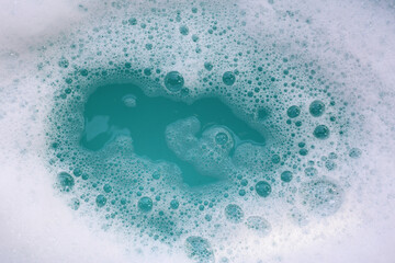 Foamy blue water surface with bubbles.