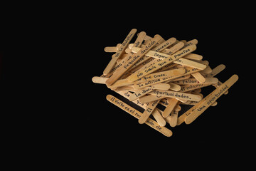 A pile of wooden skewers with words written on them. The skewers are arranged in a way that they form a message.