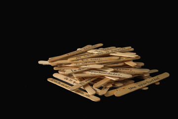 A pile of wooden sticks with words written on them. The sticks are arranged in a way that they form a message. The message seems to be about the importance of not just writing what is on the image.