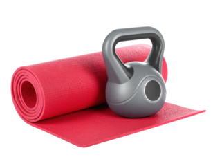 A silver kettlebell placed on a rolled-up red yoga mat.