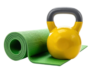 A bright yellow kettlebell rests next to a rolled green yoga mat, perfect for workouts and fitness routines.