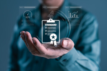 Hand showing digital certificate icon with standard, KPI, and performance dashboard for compliance, quality assurance, and professional business metrics